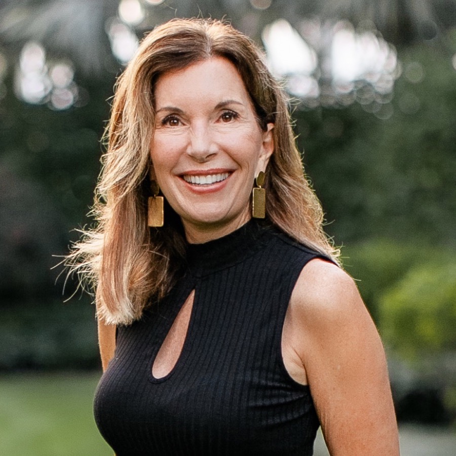 Becky Dymond, founder and executive director of LightHouse PBC, smiling outdoors